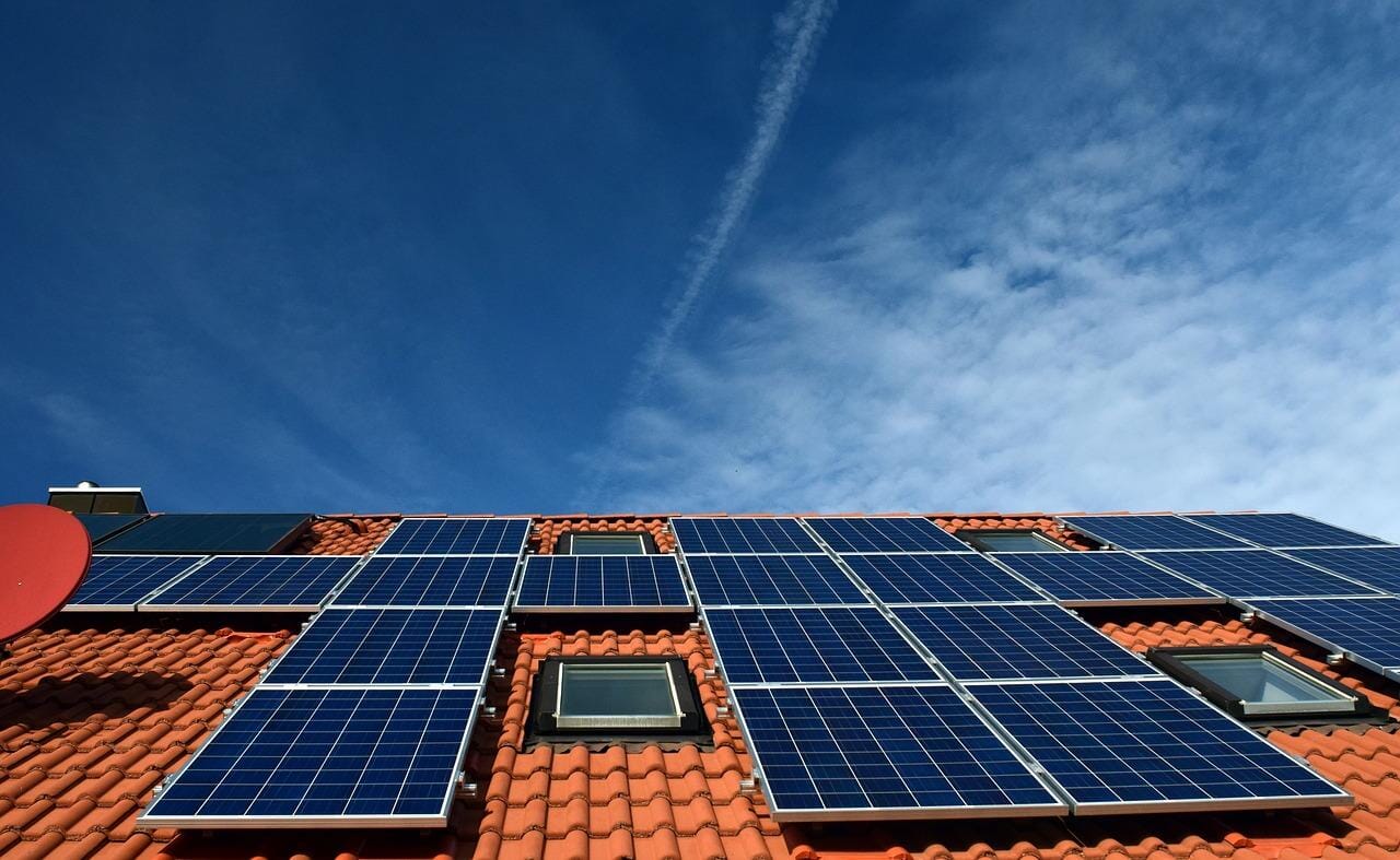solar panels setup on a rust orange roof