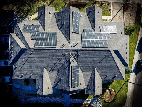 Bird's eye view of solar panels set up on a grey roofed home