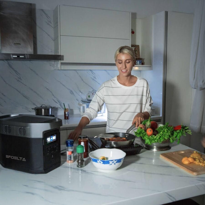 Woman cooking with an EcoFlow Delta 1800 powering a burner