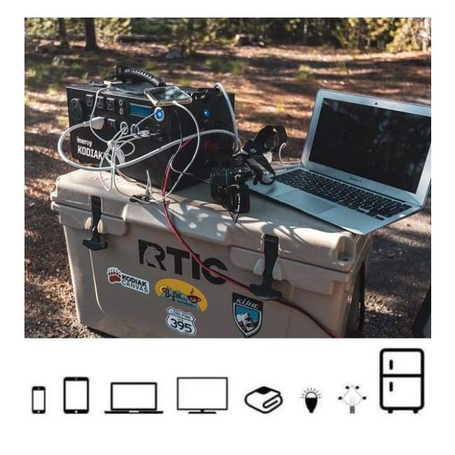 Kodiak Solar Generator by Inergy sitting on top of cooler charging a laptop and phone - Shop Solar Kits